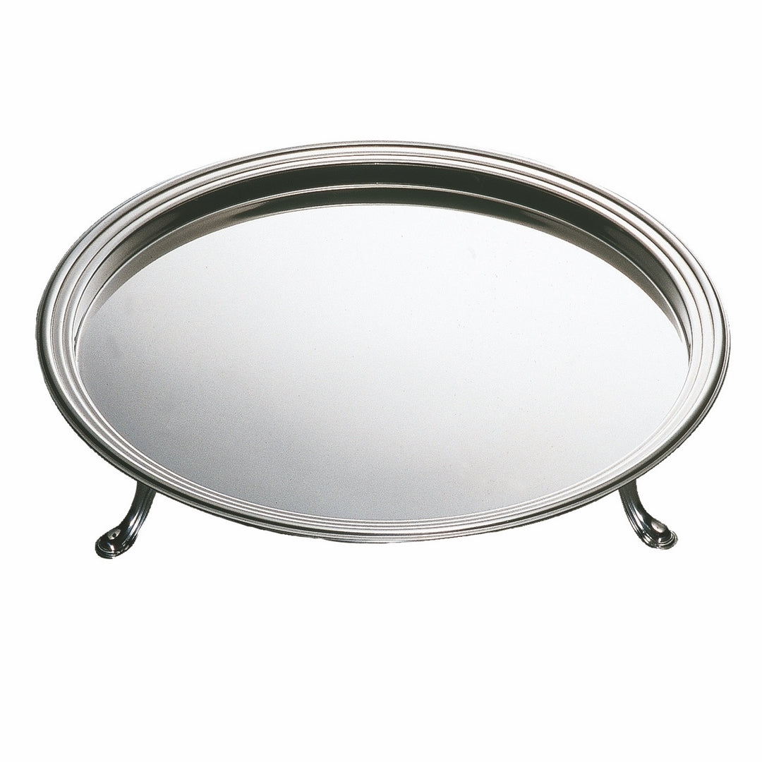 Mepra footed round stainless steel serving tray on luxury dining table with crystal glassware and candles