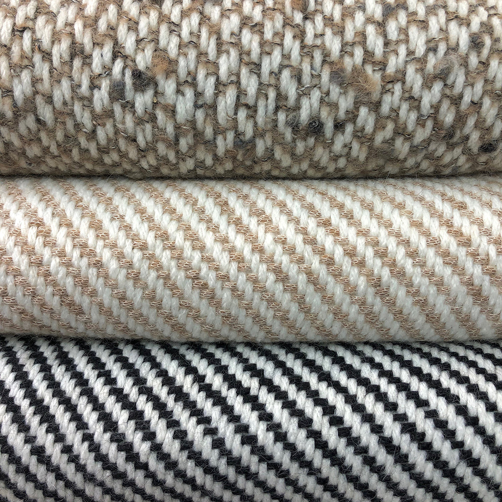 Chunky camel stripe alpaca throw folded on bed with luxury bedding, warm neutral tones