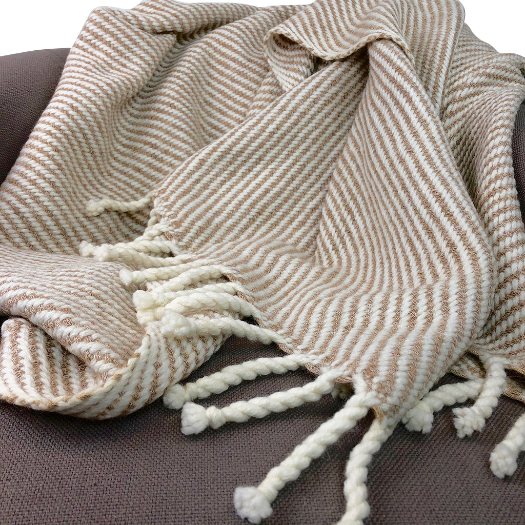 Royal Knit Peru chunky camel stripe alpaca throw with rope fringes draped over sofa, handmade in Peru