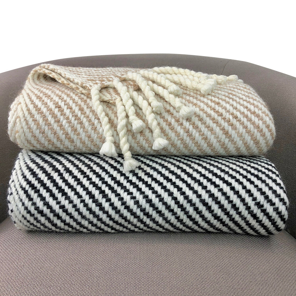 Close-up of camel and snow white herringbone stripe pattern on handmade alpaca throw blanket